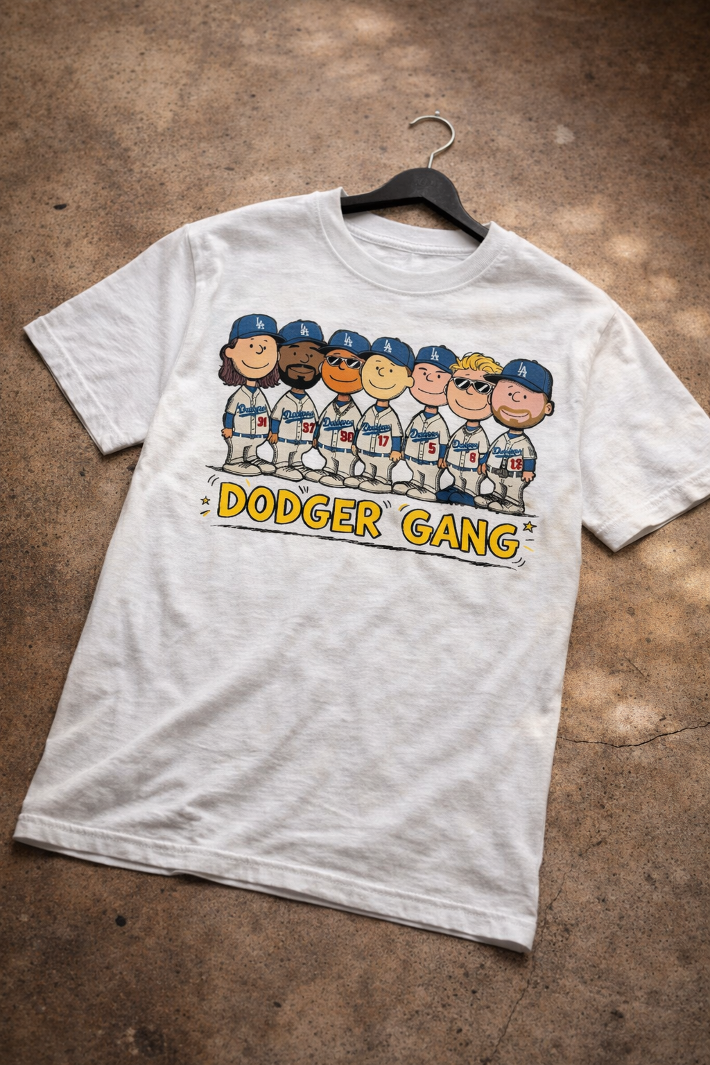 White t-shirt with 'Dodger Gang' graphic on a brown surface